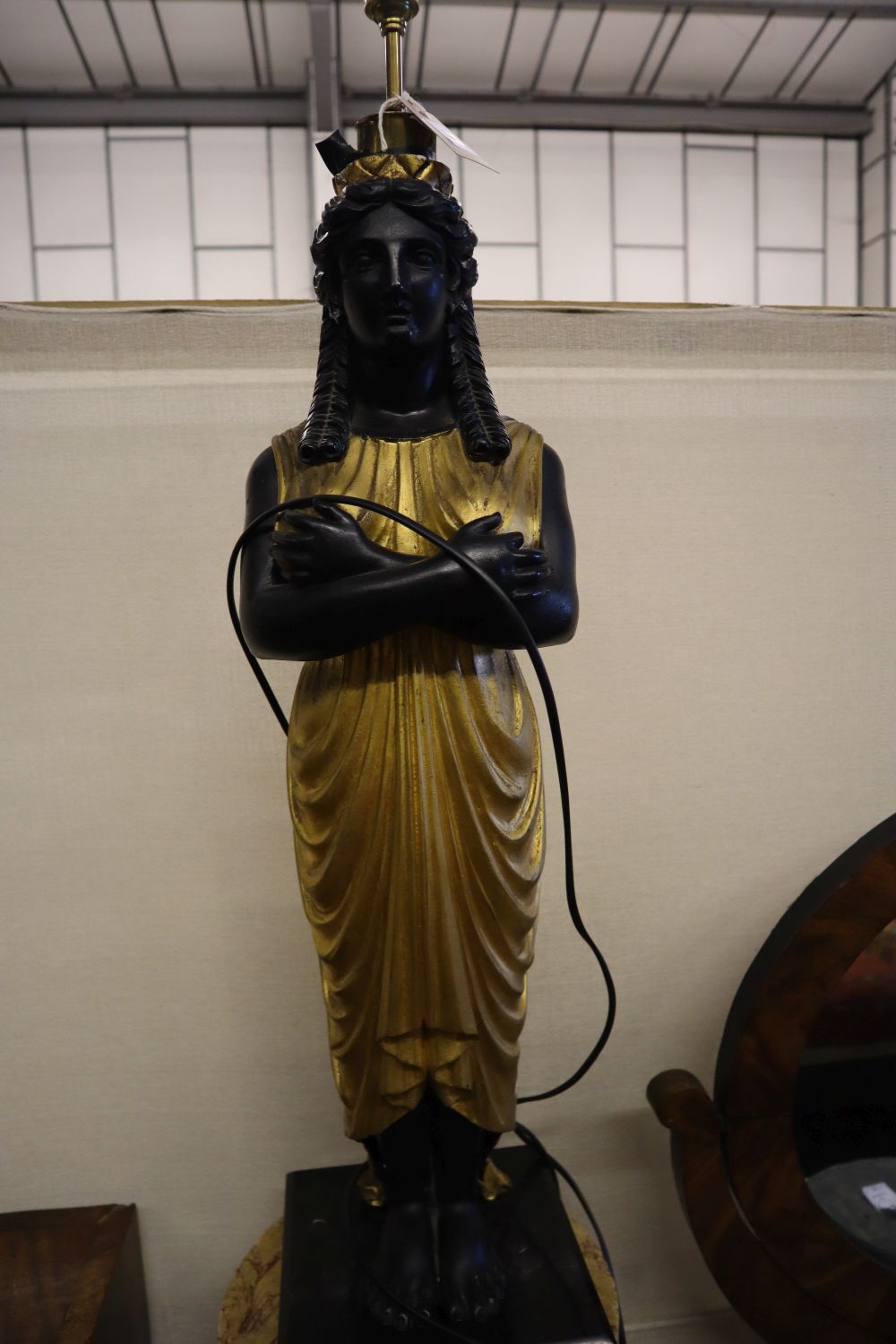 A pair of carved and giltwood Egyptian figure table lamps, on reconstituted marble columns, total height 204cm (with shades)